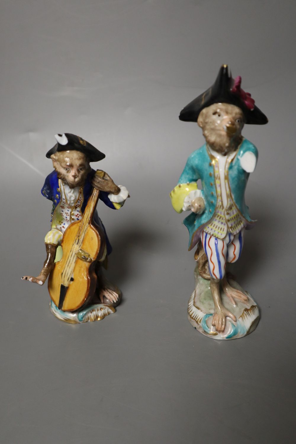 Six 19th century Meissen monkey band figures and another Volkstedt example, tallest 15cm